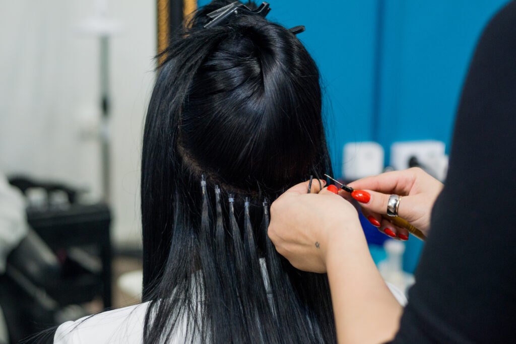 hair extensions being inserted onto hair