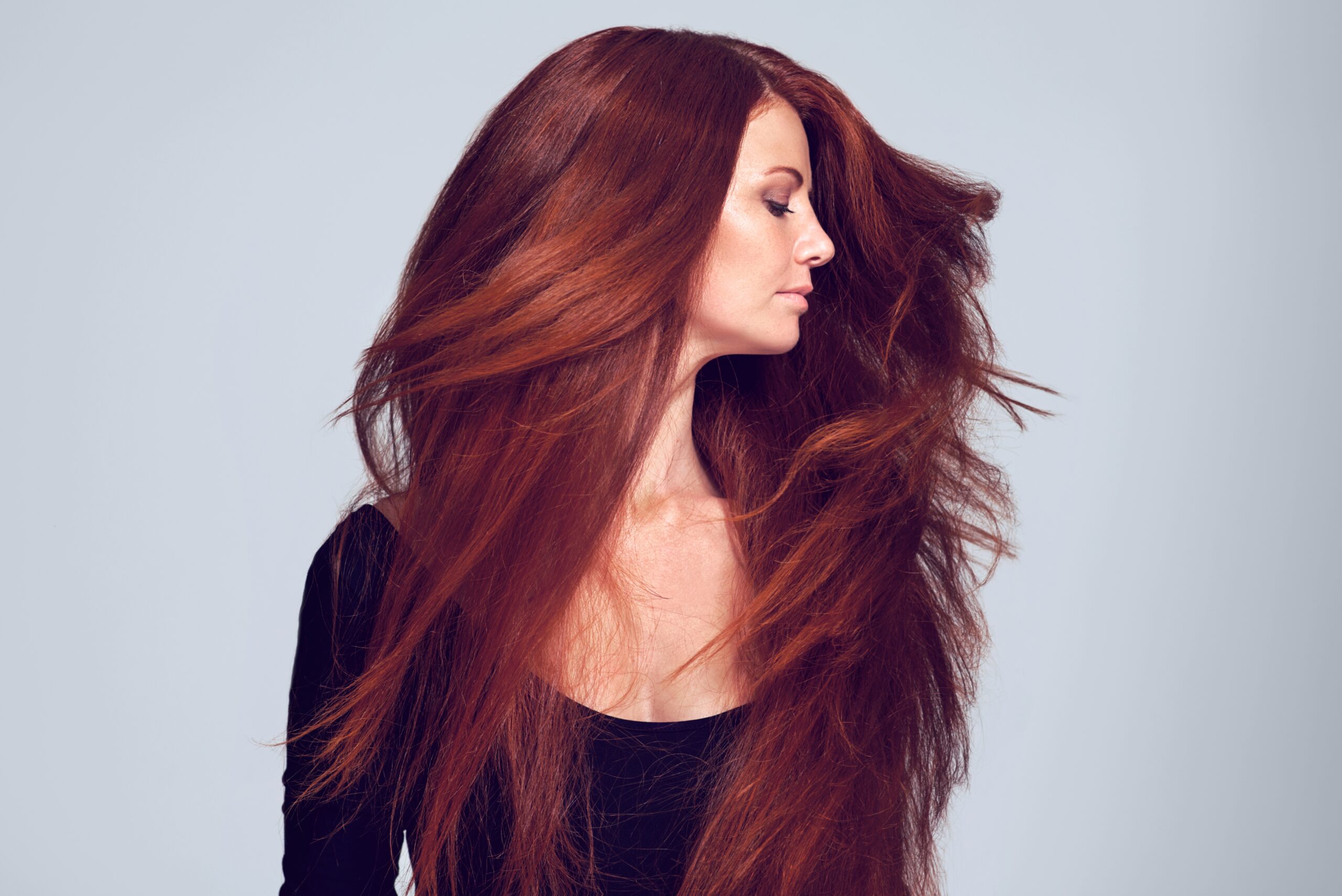 reddish/orange hair on woman as she turns her head it sways to show off the luscious strands